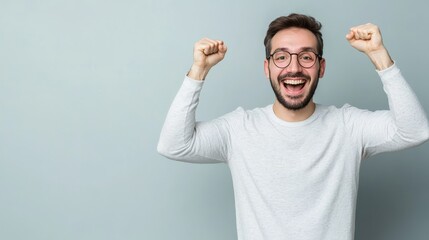 Fototapeta premium Man's Exuberant Celebration: A Portrait of Joy, Success, and Unbridled Enthusiasm with Arms Raised High in Triumph