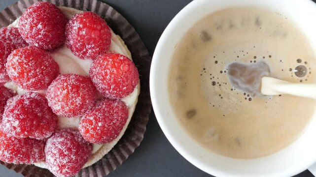 Raspberry tart. Coffee and cake. Pouring milk into coffee
