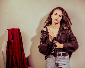 A confident woman in an artistic pose highlights her trendy style in a chic ensemble, blending...