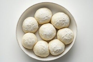 Freshly Kneaded Dough Balls Arranged in a White Bowl on Table