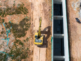 Excavator on earthmoving with grab crane with freight car,aerial view.