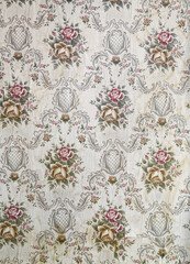 Old wallpaper on the wall. Old wallpaper for texture or background.