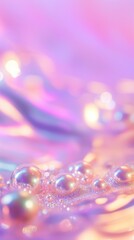 A vertical image of pearls or bubbles, resting on a shimmering, pastel-toned or holographic surface. The background is a blend of pink, purple, and yellow with soft bokeh.