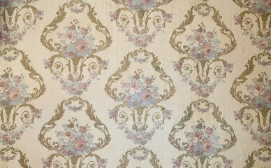 Old wallpaper on the wall. Old wallpaper for texture or background.