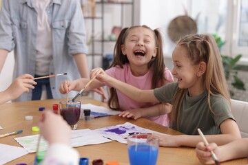 Kids with teacher at painting lesson indoors. Learning to draw