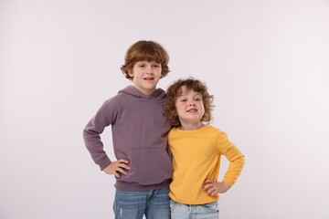 Cute little brothers hugging on white background