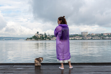 Girl and cat on the embankment in the sea bay of the city of Sevastopol Crimea