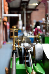 Close-up of vintage steam engine parts in a historical museum setting.