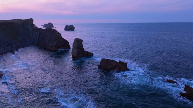 Aerial view of the sunset lights on the cliffs of Los Urros de Liencres in the Dunes of Liencres Natural Park. Pi&eacute;lagos Municipality, Costa Quebrada Geopark, Cantabrian Sea, Cantabria, Spain, Europe