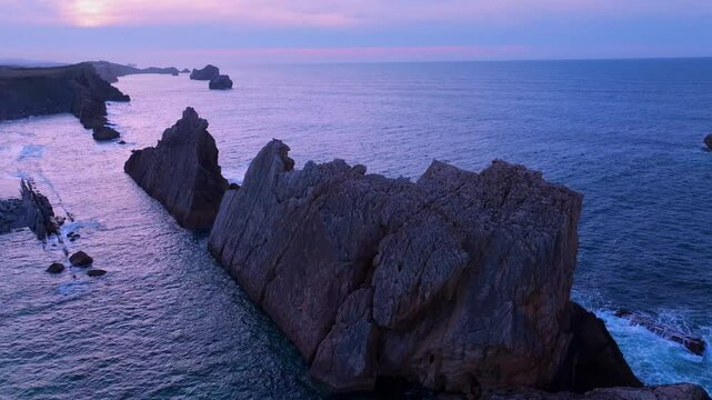 Aerial view of the sunset lights on the cliffs of Los Urros de Liencres in the Dunes of Liencres Natural Park. Pi&eacute;lagos Municipality, Costa Quebrada Geopark, Cantabrian Sea, Cantabria, Spain, Europe