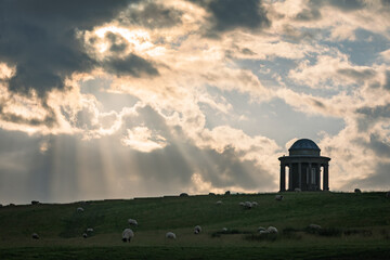 Sunset behind Brightling temple on the high weald east Sussex south east England UK