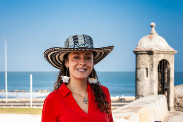Beautiful young woman tourist wearing a sombrero vueltiao in Cartagena. Colombian people. Travel concept.