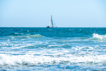 Sailboat passes through choppy Pacific waters off the California coast near Mickey&rsquo;s Beach at Mt. Tamalpais State Park, CA on May 23, 2020