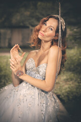 Pretty woman in nice apparel posing on countryside location