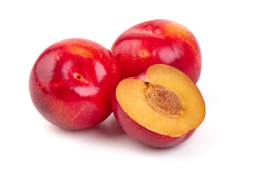 Red Plums with a Halved Plum Isolated on White Background.