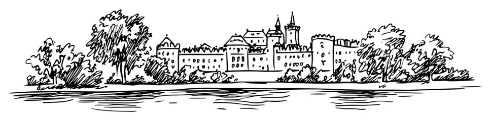 european castle complex with riverside park and trees