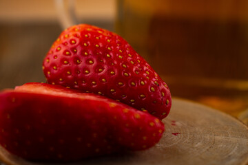 inviting close-up features a glass of green tea alongside vibrant strawberries, evoking a sense of...