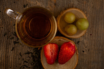 a glass of green tea, fresh strawberries, and juicy grapes, evoking a feeling of healthy indulgence and pure wellness. Ideal for clean eating, healthy recipes, or mindful lifestyle content