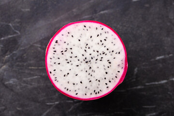 Fresh dragon fruit, pitahaya. Black marble background. Close up. Top view.