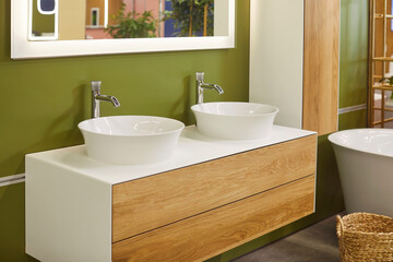 Modern bathroom with ceramic bathtub, double sinks and mirror above it, there are no people. Green walls. Bathroom interior design. Bathing area in hotel. Minimalist design. 3D rendering. 