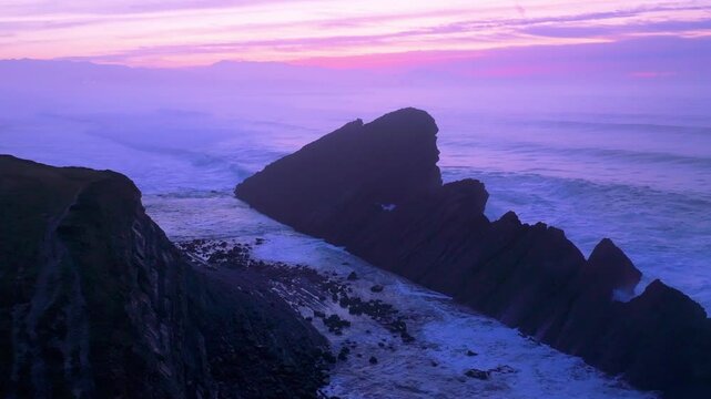 Aerial view of the sunset lights on the cliffs of Madero Beach in the Dunes of Liencres Natural Park. Pi&eacute;lagos Municipality, Costa Quebrada Geopark, Cantabrian Sea, Cantabria, Spain, Europe