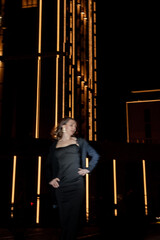a girl in a night city, a beautiful young girl walking around the night city in an evening dress and heels, blurred photo in out of focus
