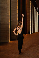 A girl in a night city, a beautiful young girl walks through the night city in an evening dress and heels