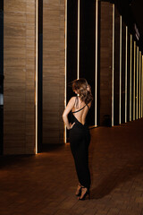 A girl in a night city, a beautiful young girl walks through the night city in an evening dress and heels