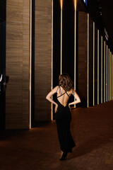 A girl in a night city, a beautiful young girl walks through the night city in an evening dress and heels