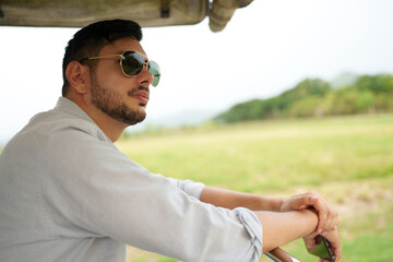Handsome man entrepreneur checking  in organic vineyard.
