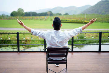 Handsome man entrepreneur relaxing at his organic vineyard.