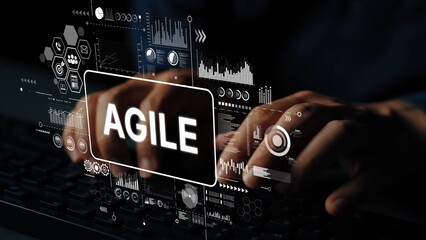Hands typing on keyboard with digital interface showcasing agile methodology in modern software...
