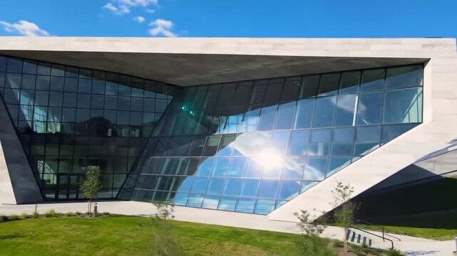 Modern Architecture: Angular Building Design with Glass Fa?ade on Green Lawn