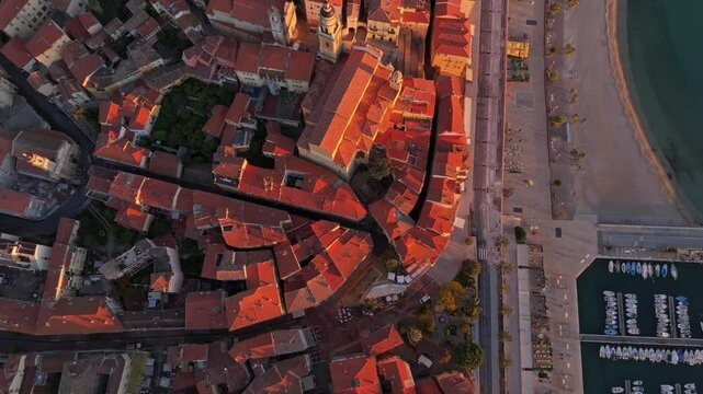 Aerial of Menton beachside promenade in soft sunrise, France. Aerial drone video