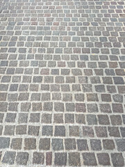 Stone paved floor background texture. Cobblestone grey footpath above view