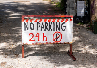 NO PARKING road sign. No parking 24 h text and letter P with a slash.