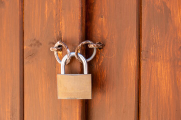 Locked door. Closed padlock on an old wooden door, closeup