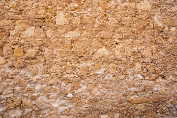 Stone wall background texture. Natural brown color rocks and mortar backdrop