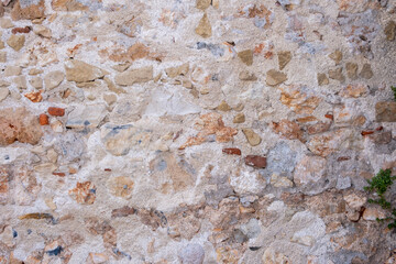 Weathered stone wall background texture. Natural rocks and mortar backdrop