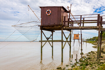 Fishing huts on stilts in Lamarque, Gironde estuary, inspired by Chinese fishing nets, called Carrelets in France, still popular in South West France by the Atlantic Ocean