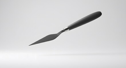Fototapeta premium Sleek Black Palette Knife Studio Shot Against White Background Professional Photography of Artist Tool