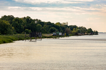 Fishing huts on stilts in Lamarque, Gironde estuary, inspired by Chinese fishing nets, called Carrelets in France, still popular in South West France by the Atlantic Ocean