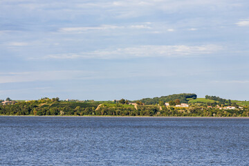 Cote de Bourg vineyard, sloping into the Garonne River, near Blaye, seen from Gironde estuary, sunny summer afternoon, South West France, Atlantic Ocean