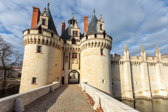 Dissay castle, near Poitiers, in France, full view under the sun, sometimes referred as Sleeping Beauty castle, with moat and bridge, now rehabilitated in a luxury hotel