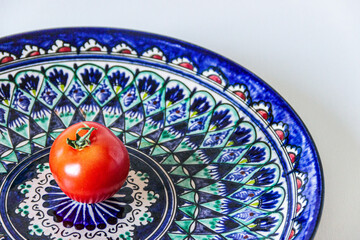 fresh tomato on traditional oriental ceramic plate