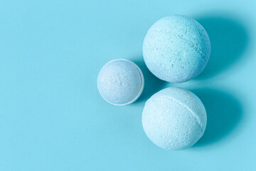 Bright blue bath bombs arranged quietly on a smooth surface during late afternoon light