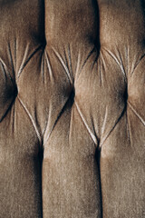 Close-up view of a tufted fabric surface showcasing texture and details on upholstery