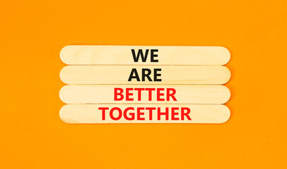 We are better together symbol. Concept words phrase We are better together on beautiful wooden stick. Beautiful orange paper background. Business We are better together concept. Copy space.