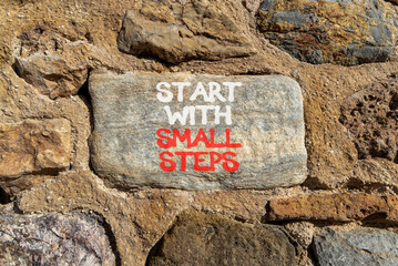 Start with small steps symbol. Concept words phrase Start with small steps on beautiful grey stone...