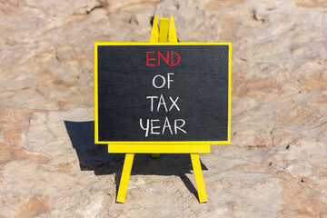 End of tax year symbol. Concept words phrase End of tax year on beautiful black blackboard....